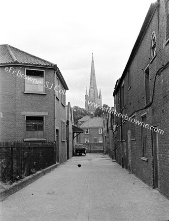 CATHEDRAL WITH STREET AND HOUSES IN FOREGROUND